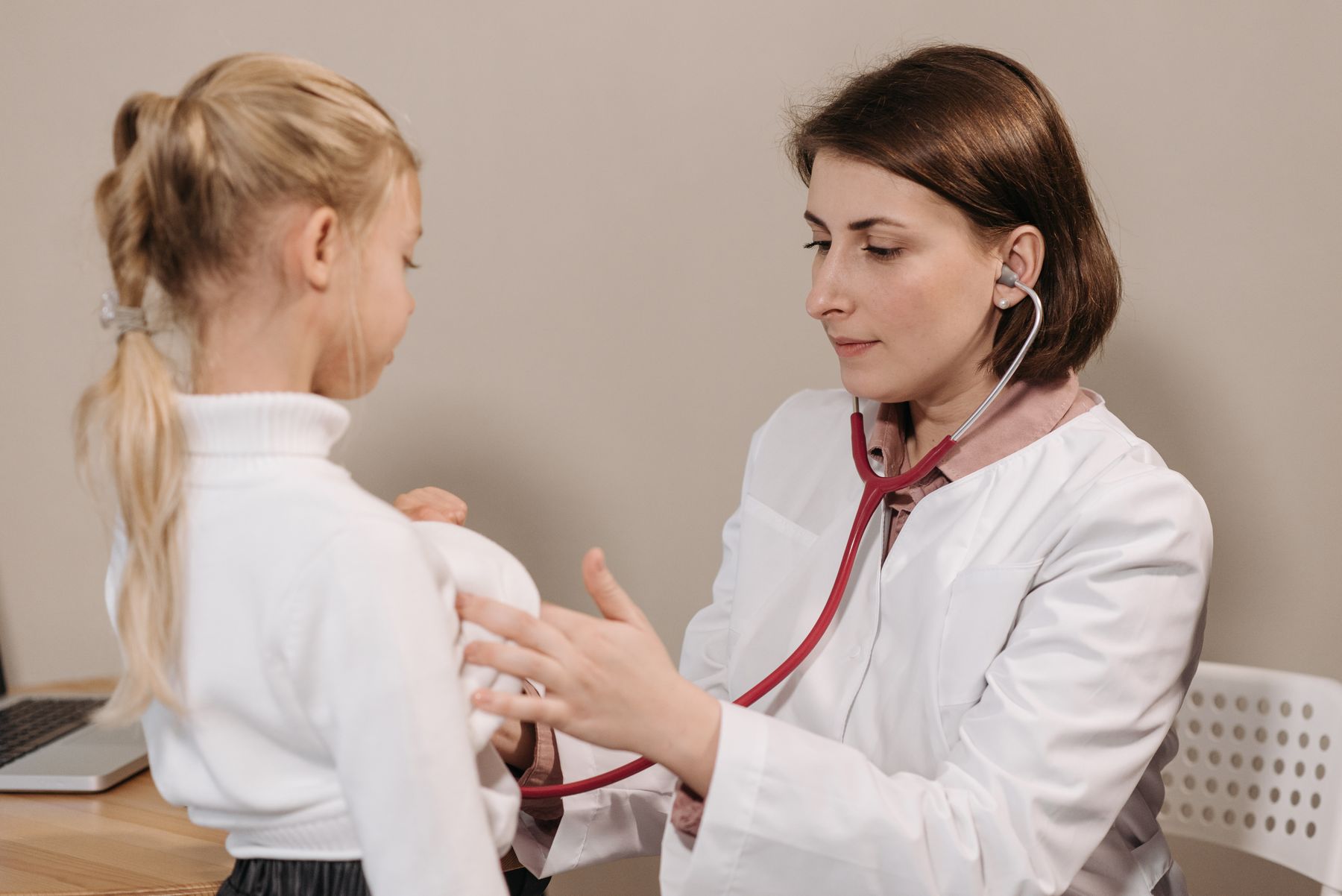 Doctor listening to a child's heartbeat with a stethoscope
