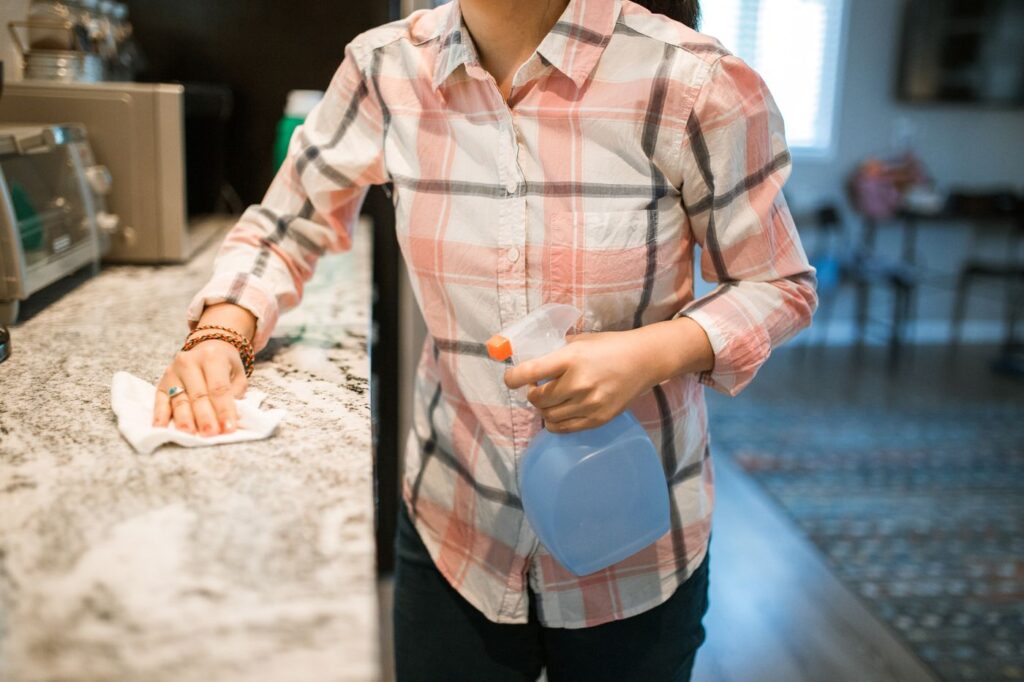 Woman wiping down a kitchen counter
