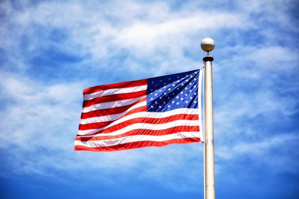 American flag flying against a blue sky