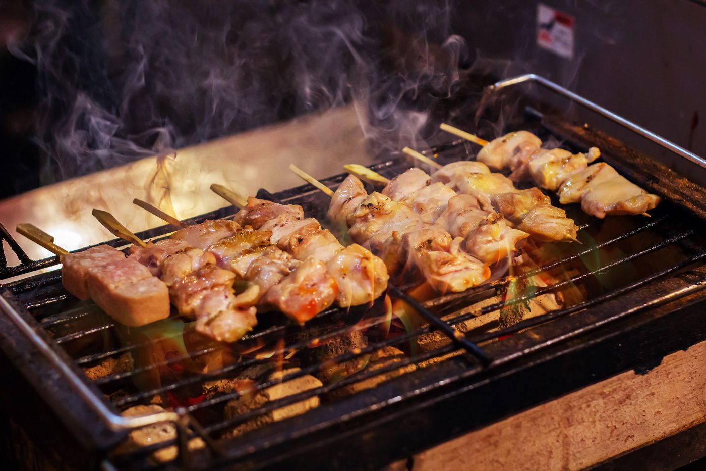 Chicken skewers cooking on a grill
