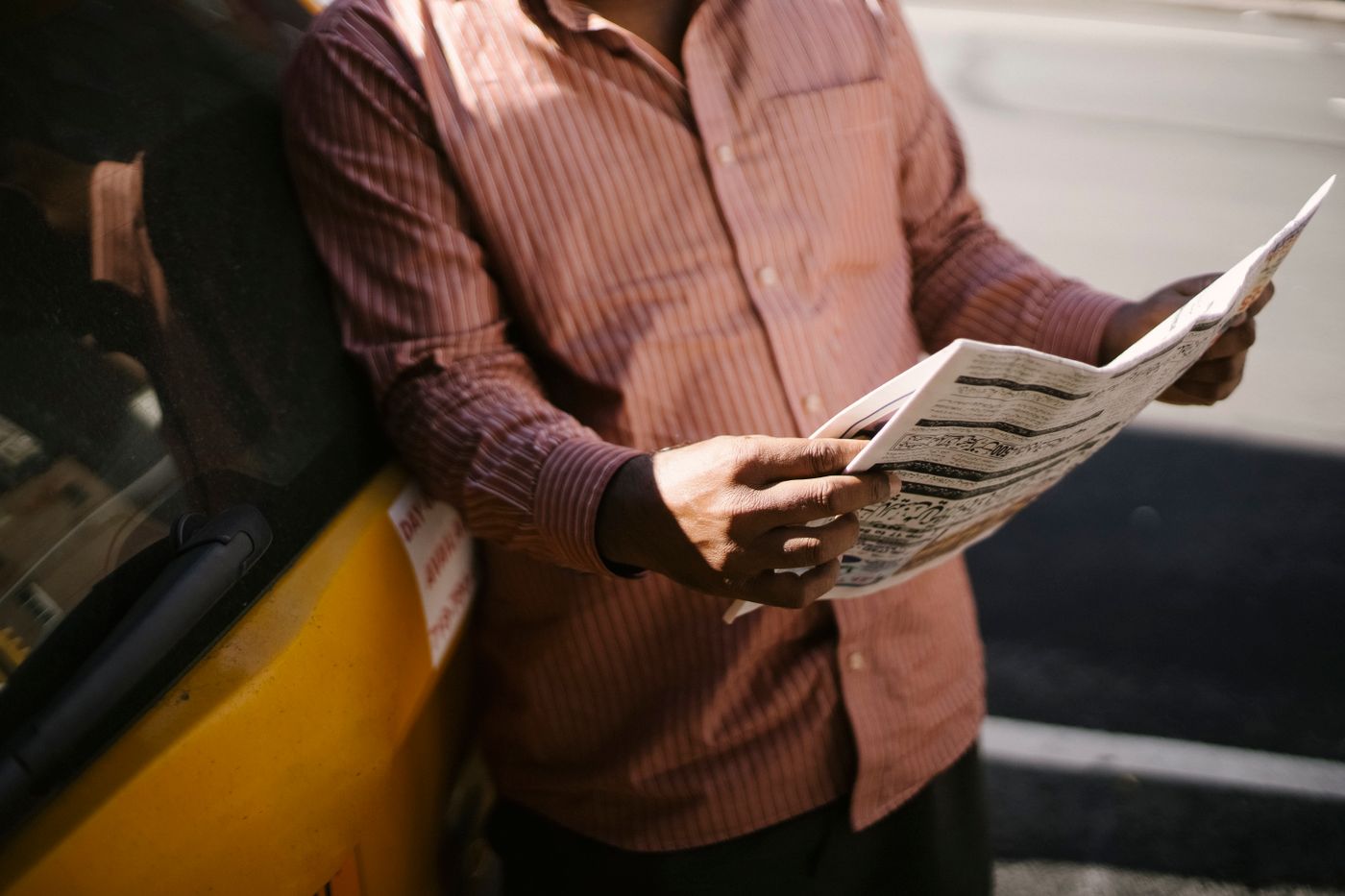 Hands holding an open newspaper