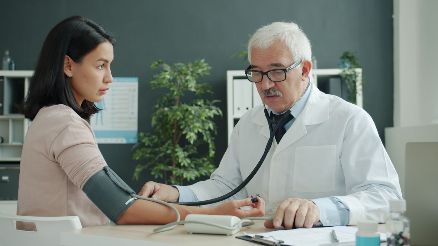 Doctor checking a patient's blood pressure